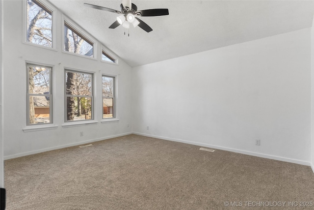 carpeted spare room with ceiling fan, high vaulted ceiling, and a textured ceiling