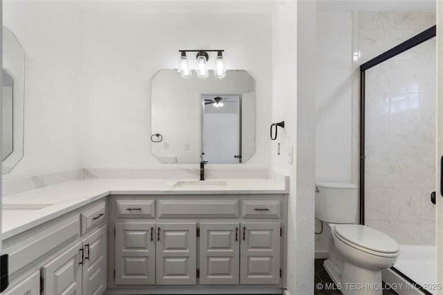 bathroom with vanity, an enclosed shower, ceiling fan, and toilet