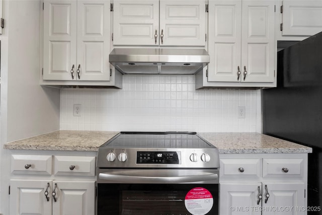 kitchen with white cabinetry, black refrigerator, and stainless steel electric range