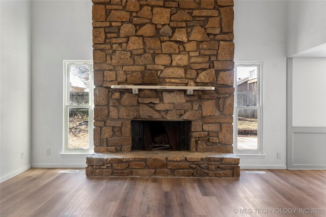 interior details featuring hardwood / wood-style flooring and a fireplace