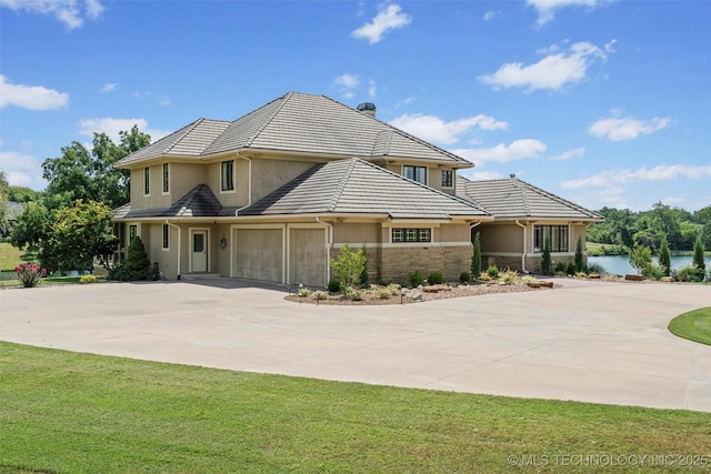 view of front facade with a front yard and a water view