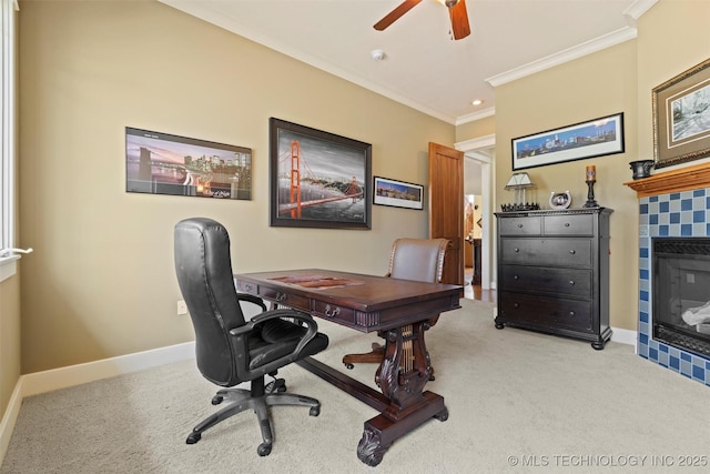 carpeted office space with crown molding, ceiling fan, and a fireplace