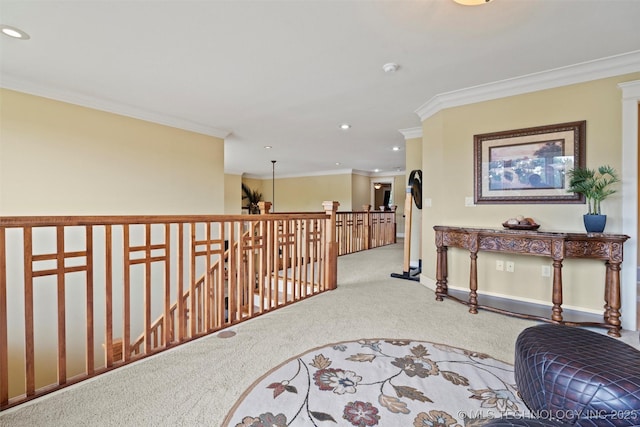 hall with carpet floors and ornamental molding