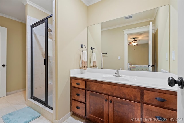 bathroom featuring vanity, tile patterned flooring, a shower with door, and ornamental molding