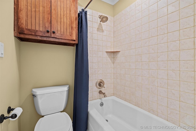 bathroom featuring shower / tub combo and toilet