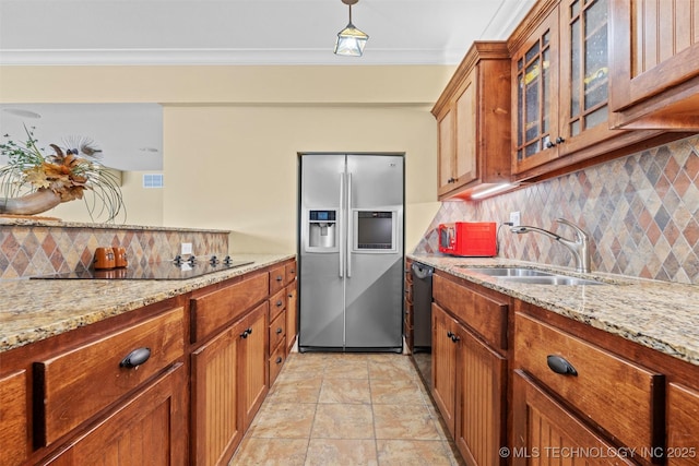 kitchen featuring light stone counters, sink, crown molding, and stainless steel refrigerator with ice dispenser