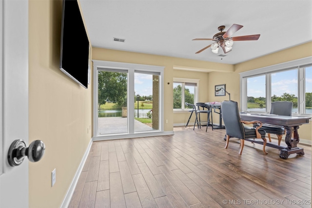 office with wood-type flooring and ceiling fan