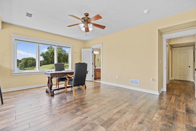 home office featuring hardwood / wood-style floors and ceiling fan