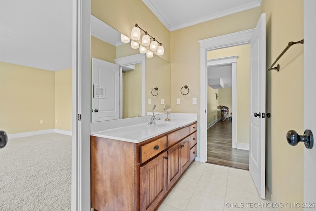 bathroom with crown molding, tile patterned floors, and vanity