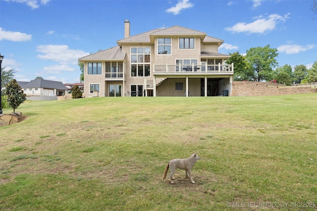 back of property with a wooden deck and a yard