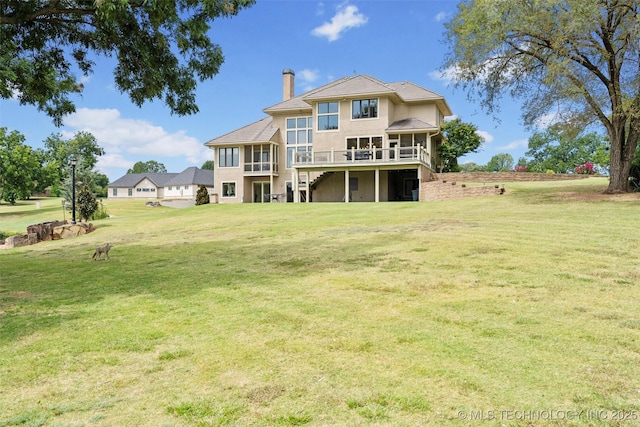 back of house featuring a yard and a deck