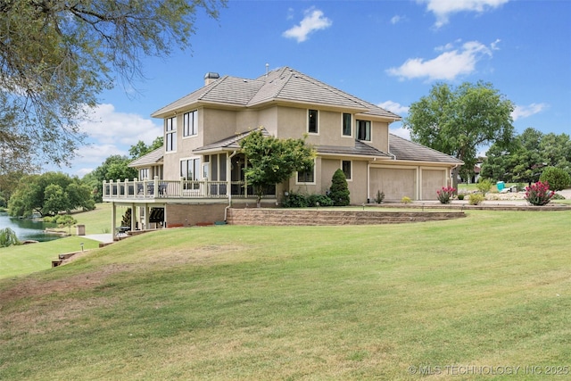 rear view of property with a lawn and a deck