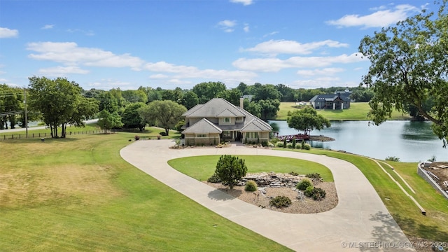 view of property's community with a water view and a yard