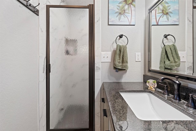 bathroom featuring an enclosed shower and vanity