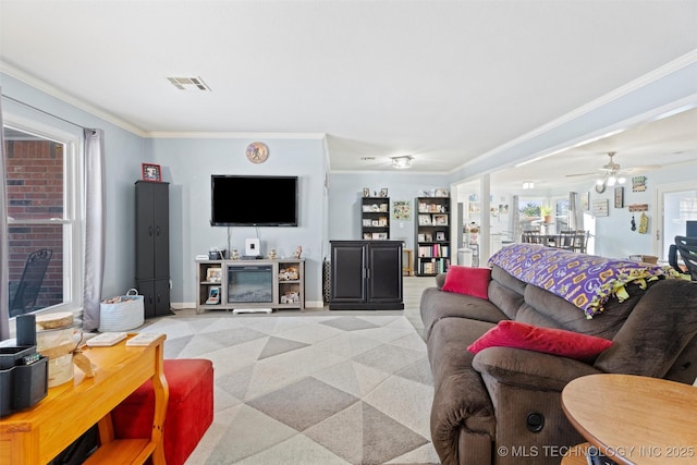 living room featuring ornamental molding and ceiling fan