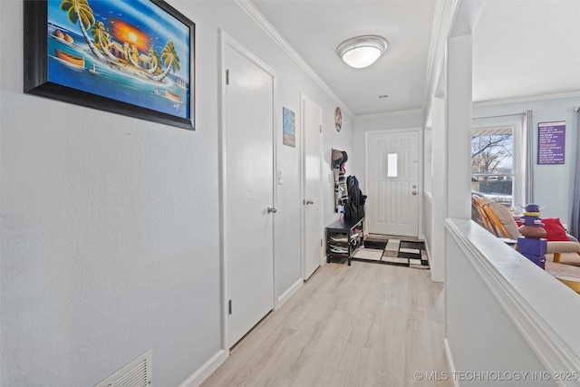 corridor with crown molding and light wood-type flooring