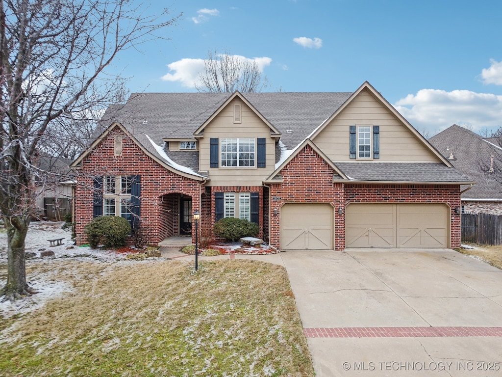 view of front of property with a garage and a front lawn