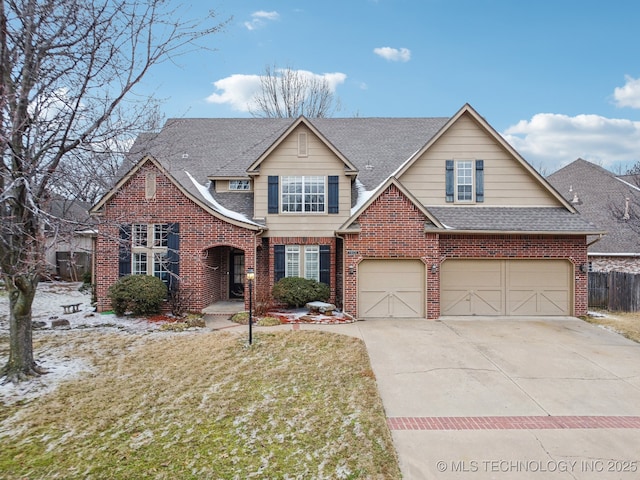 view of front of property with a garage and a front lawn