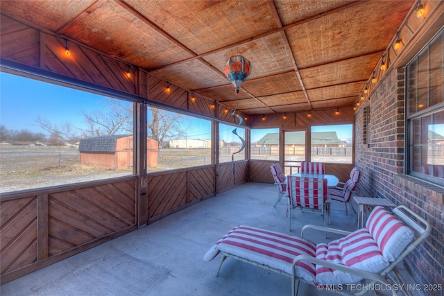 unfurnished sunroom featuring wooden ceiling