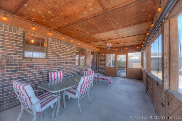 unfurnished sunroom featuring track lighting