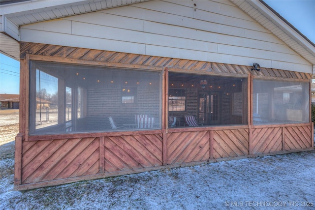 view of property exterior with a sunroom