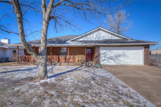 ranch-style house with cooling unit, a garage, and covered porch