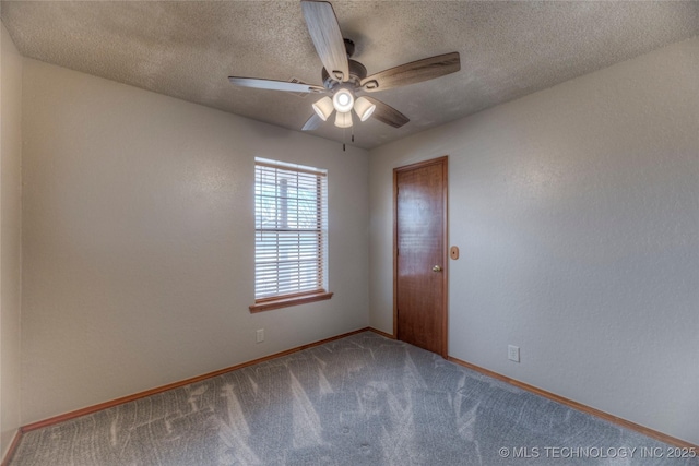 carpeted spare room featuring a textured ceiling and ceiling fan