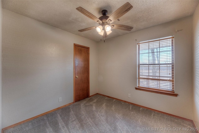 carpeted empty room featuring ceiling fan and a textured ceiling