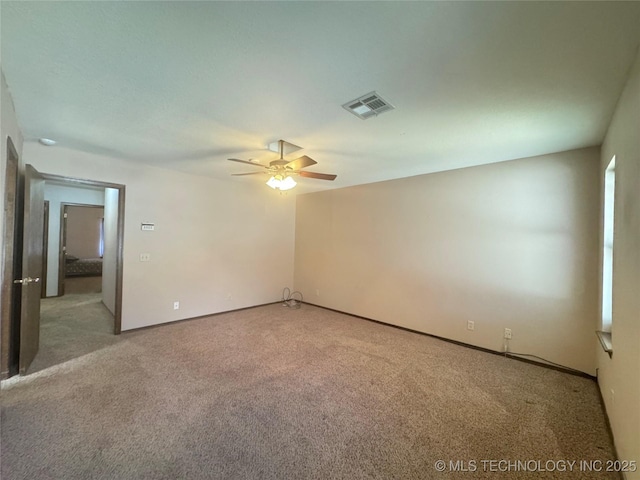 carpeted empty room with ceiling fan