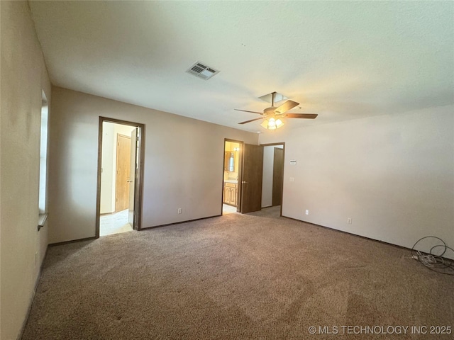 spare room featuring ceiling fan and carpet