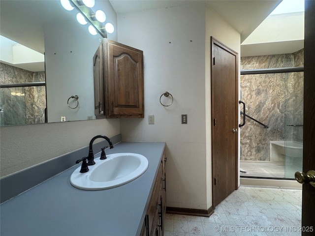 bathroom featuring vanity and a shower with door