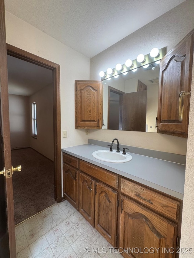 bathroom with vanity and a textured ceiling