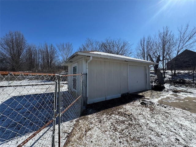 view of snow covered exterior featuring a garage