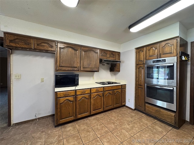 kitchen featuring light tile patterned floors and black appliances