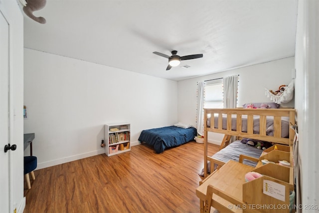 bedroom with hardwood / wood-style flooring and ceiling fan