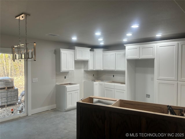 kitchen with hanging light fixtures and white cabinets