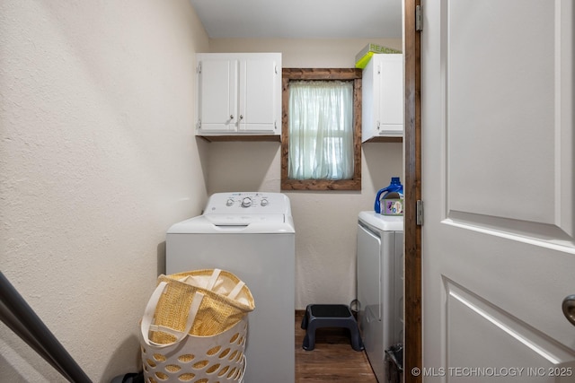 clothes washing area with cabinets, hardwood / wood-style floors, and washer and dryer