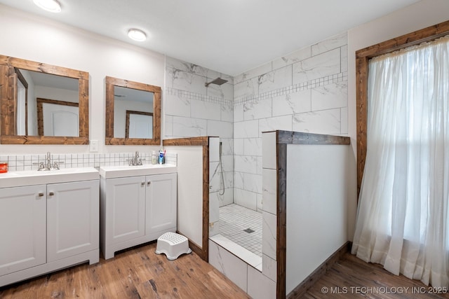 bathroom with vanity, hardwood / wood-style flooring, and tiled shower