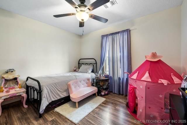 bedroom with dark wood-type flooring and ceiling fan