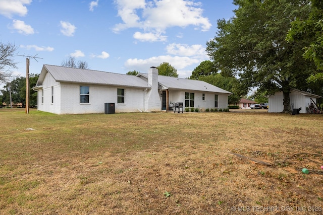 rear view of house with a yard