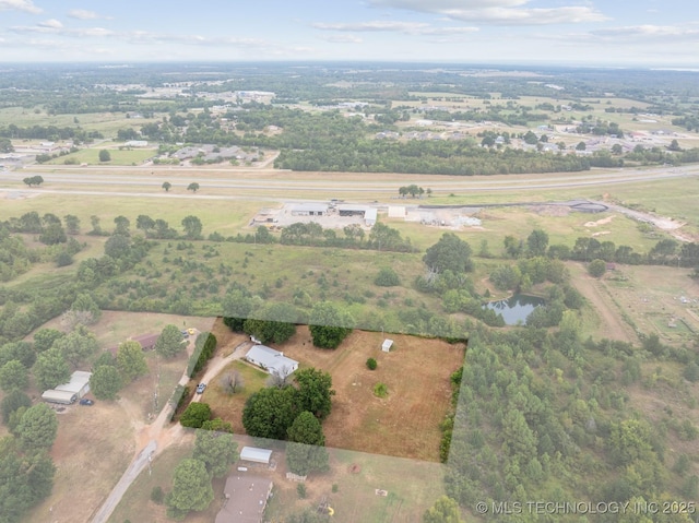 birds eye view of property with a rural view