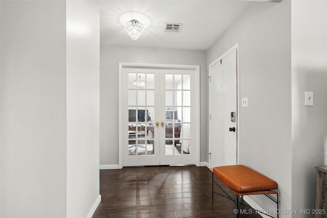 entryway with dark hardwood / wood-style flooring and french doors