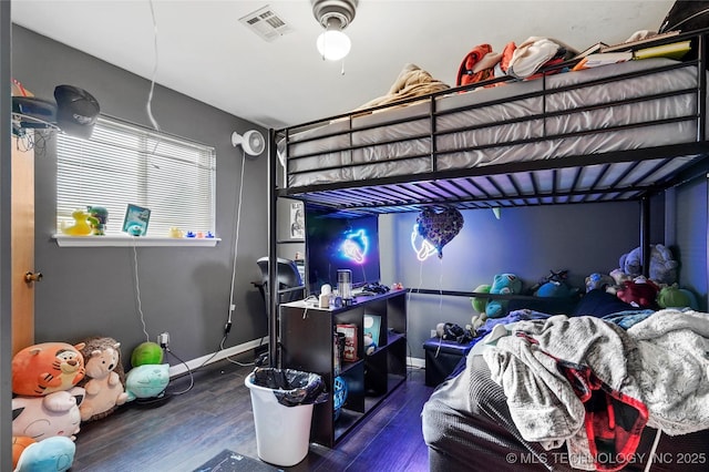 bedroom with dark wood-type flooring