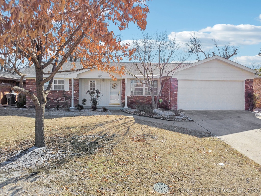 ranch-style house with a garage and a front yard