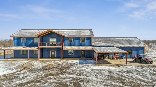 9501 S 4170th Rd, Claremore, OK 74017 - view of front facade featuring metal roof, a balcony, and board and batten siding