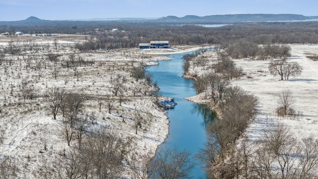 birds eye view of property with a water and mountain view