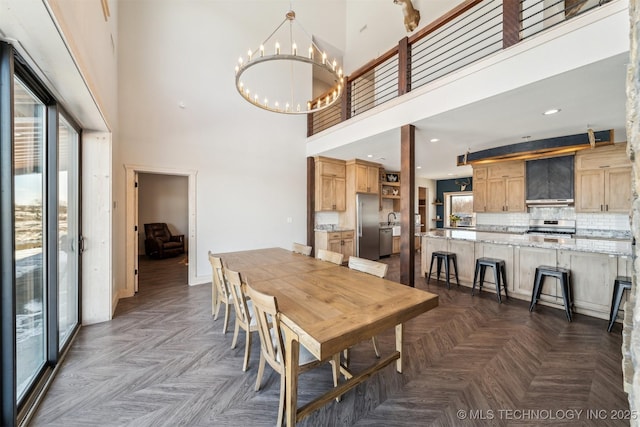 9501 S 4170th Rd, Claremore, OK 74017 - dining room with a chandelier, a towering ceiling, and baseboards