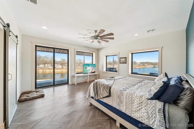9501 S 4170th Rd, Claremore, OK 74017 - bedroom featuring a barn door, access to outside, recessed lighting, multiple windows, and baseboards