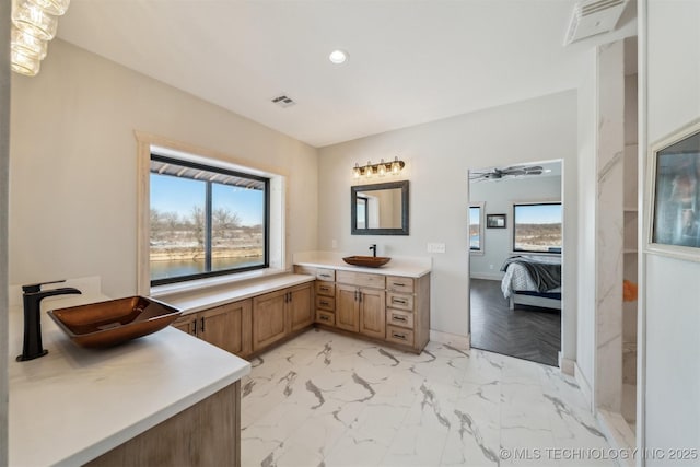 ensuite bathroom featuring plenty of natural light, recessed lighting, ensuite bath, and visible vents