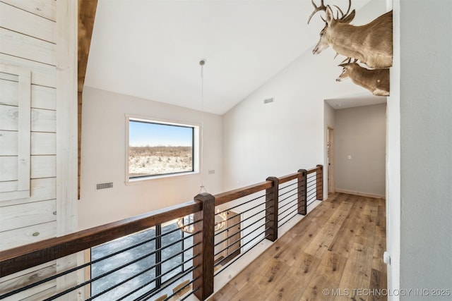 9501 S 4170th Rd, Claremore, OK 74017 - hall featuring wood-type flooring, an upstairs landing, and vaulted ceiling